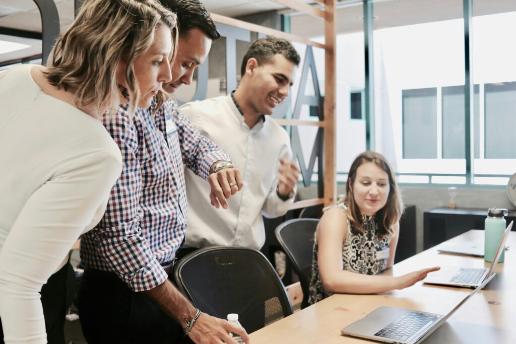 Group of IT Support Technicians gathered around a desk